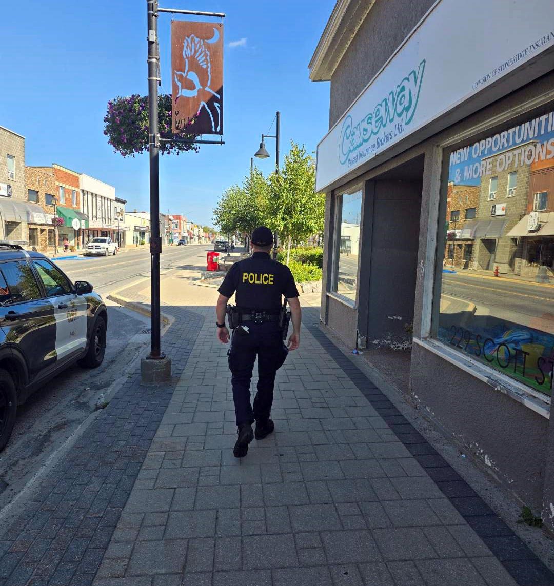 OPP Officer walking on sidewalk in the community