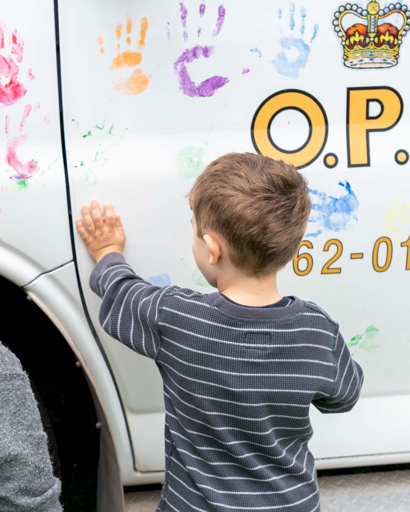 Child touching police car